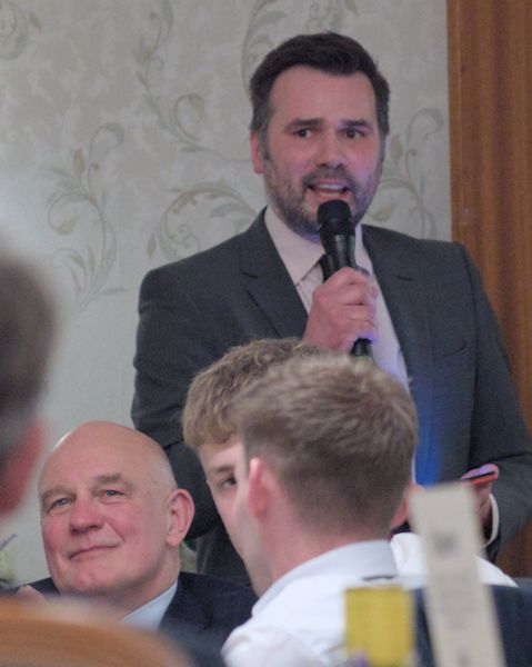 Steven Barker speaking into a microphone